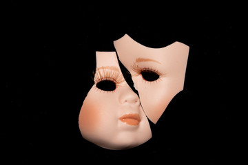 Broken Doll Head Face On Black Background