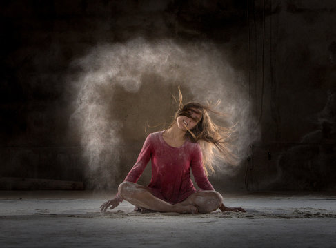 Young woman between fog in darkness