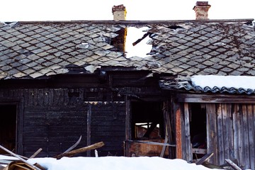 An old house that is destroyed by fire from a natural disaster or the negligence of people. Traces of fire are visible on the house.