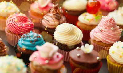 Tasty Colorful cupcakes on background