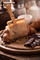 Coffee cup with a croissant and fresh coffee