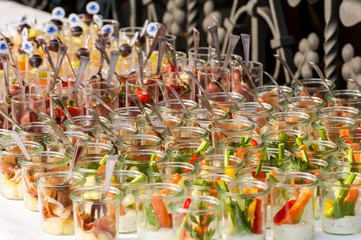 colorful appetizers in small glasses in rows