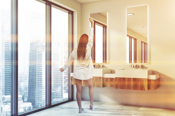 Woman in double sink bathroom