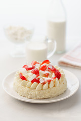 Delicate strawberry cheesecake with coconut. Delicious homemade cake with Fresh berries on light table.