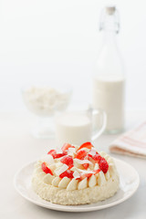 Delicate strawberry cheesecake with coconut. Delicious homemade cake with Fresh berries on light table.