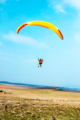 Paraglider in the air against the sky