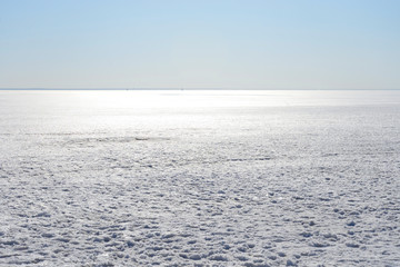 Frozen sea at sunny day.