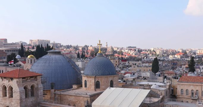 Slow zooming out from two domes and belfry of the Church of the Holy Sepulchre in Jerusalem, Israel