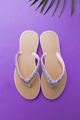 beautiful woman's beach flip-flops on the violet or purple background. beach summer concept and holiday concept, top view
