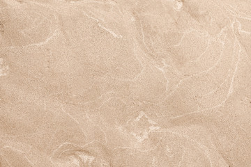 A top down shot of a dry river beige sand bottom full of texture and salt marks. Useful as abstract background.
