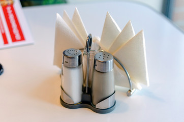 Salt and pepper shakers on wooden table © Владимир Феофанов