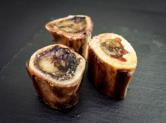 Baked beef brain bones on a dark background
