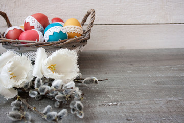 Easter background: colorful Easter eggs decorated with lace, tulips, base