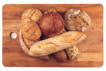different types of bread on wooden kitchen cutting board