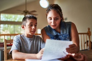mother helping son with homework
