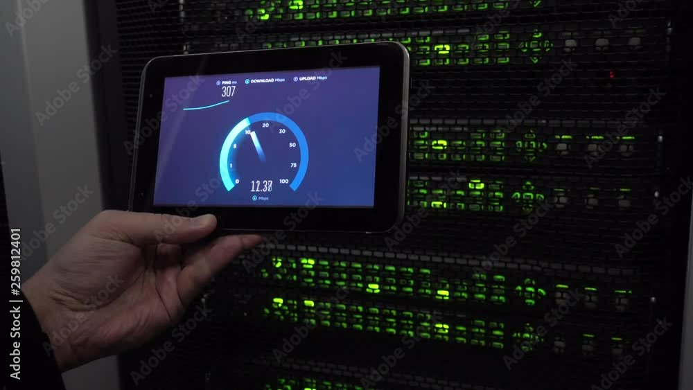 Poster it engineer measures network speed with a tablet computer in hand. leds blink. on background server 