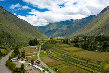 Fototapeta na wymiar Aerial view of Inca agriculture terraces at the Sacred Valley of the Incas near Urubamba town. Mountains alpine landscape in a region of Cusco, Peru.