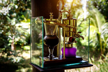 Making legendary coffee, Kopi Luwak, in a vintage syphon. Bali, Indonesia
