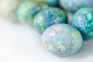 Easter painted eggs . Blue-green shades on white background. The theme of the Easter holiday. 