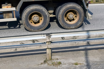 Truck rides on the road. Wheels closeup.