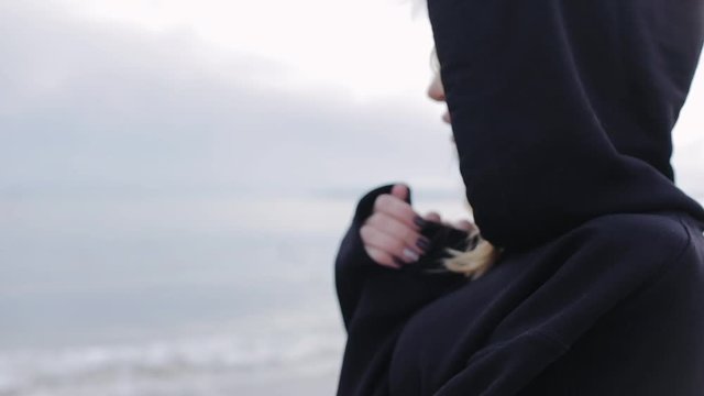Anxiety, experience, loneliness. Prayer to God. The state of mind on the face of a young girl in a black sweater. The Pray.
