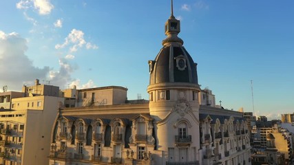 Aerial drone view of art nouveau architecture style building at the sunset, located near the Congress square, Buenos Aires, Argentina.