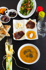 Traditional Ramadan Dinner Table  with symbolic foods on the black surface.Muslim worship of Ramadan.