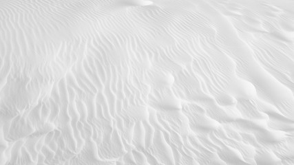 Fototapeta na wymiar White sand texture background with wave pattern and insect trails 