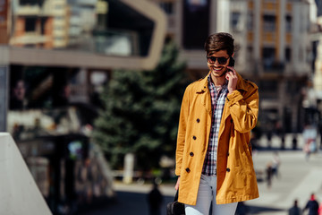Fototapeta premium Modern businessman on mobile phone in urban place