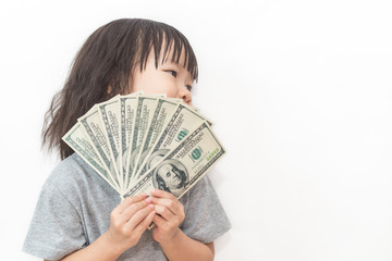 Portrait of cute little asian girl holding money isolated on white background. Small happy asian toddler girl with her allowance dollar note. 