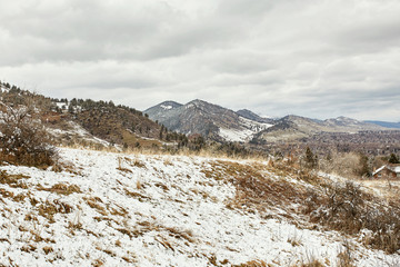 Fototapeta na wymiar A Spring snow storm covers the mountain range, valley and Flatirons of Chautauqua Park, in Boulder, Colorado