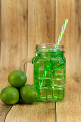 Lemonade summer cold drink with wooden background