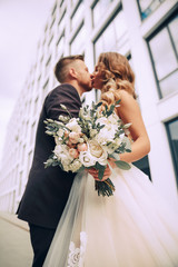 Couple in love on a walk in the city.The couple on the background of a modern building.Wedding photo