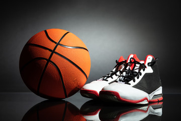 Sport Shoes And Basketball On Desk