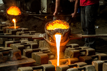 metal casting process with red high temperature fire in metal part factory