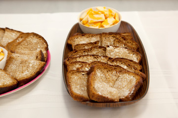 buttered home made brown bread with cheese at a party table 