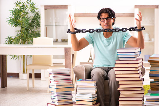 Male student with many books at home 