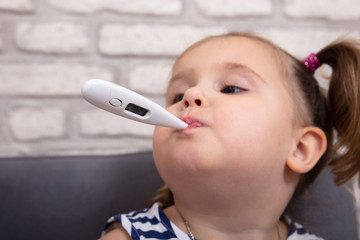 Sick Girl With A Thermometer In Her Mouth