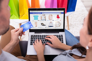 Smiling Couple Shopping Online On Laptop