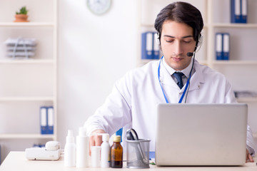 Young male doctor in telemedicine concept 