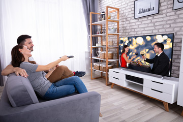 Couple Watching Television At Home