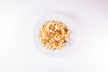 noodle dish with mussels and clams on white background