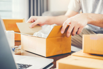 SME freelance man working with packaging startup entrepreneur small business owner at home,Online business seller packaging and delivery concept