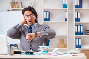 Young handsome businessman in budget planning concept 