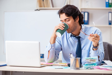 Young handsome businessman in budget planning concept 