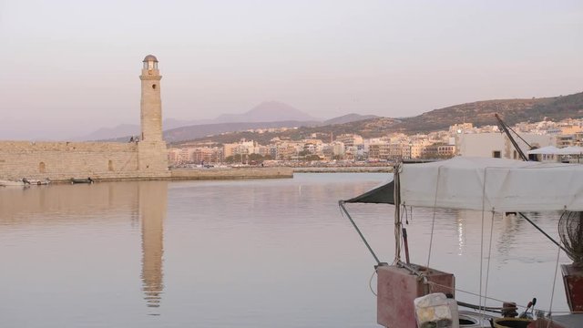 Sunset over Lighthouse at old Venetian harbour, Rethymno, Crete