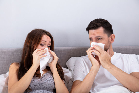 Young Couple Blowing Their Nose