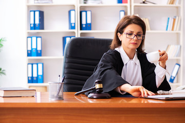 Middle-aged female doctor working in courthouse 