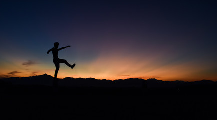 Silhouette of man doing walking at sunset, Concept lifestyle freedom vacation travel.