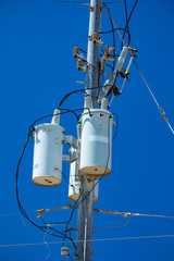 Electric pole with a transformer and wires